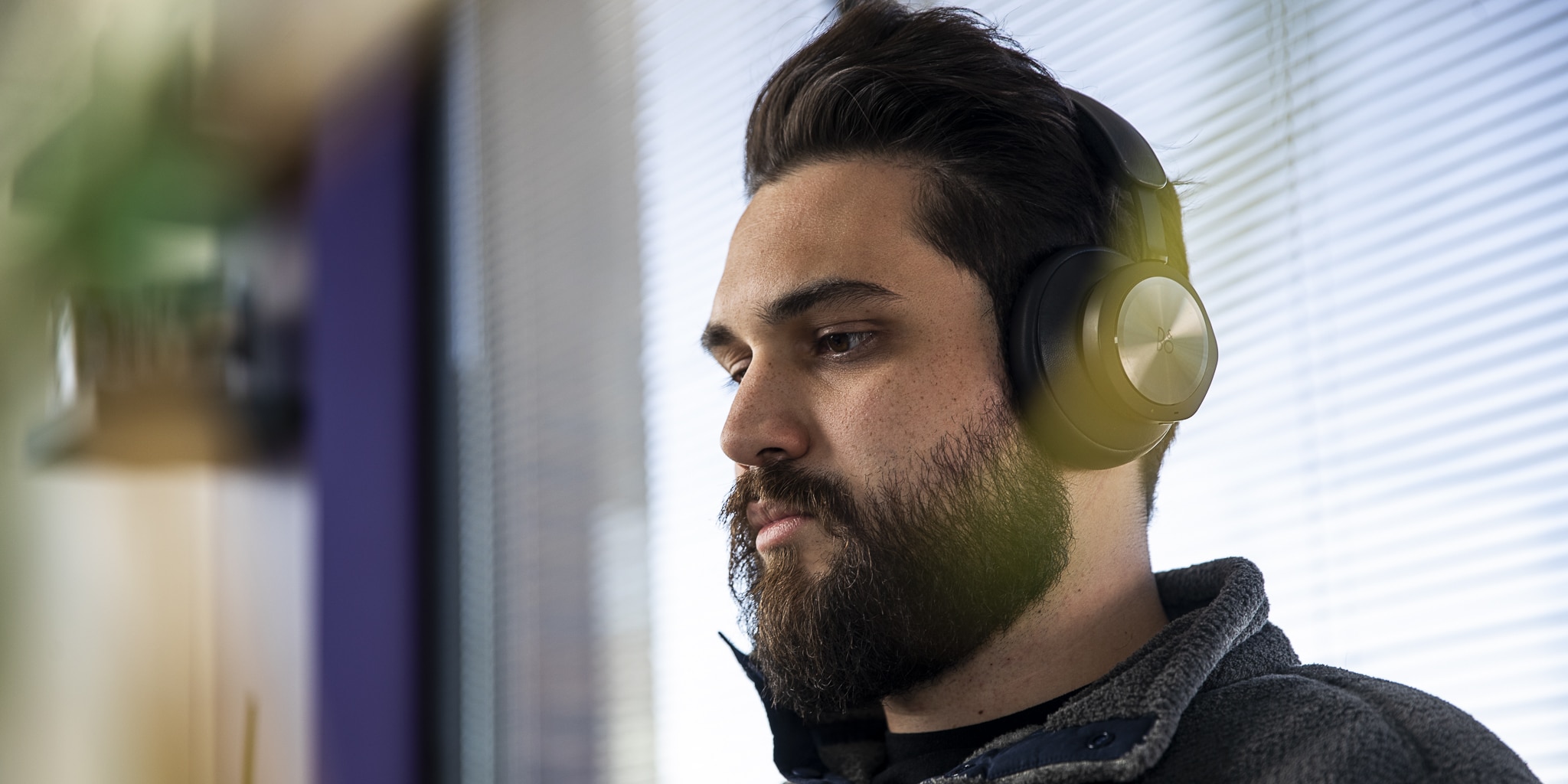 A man listening to a podcast on his headphones.